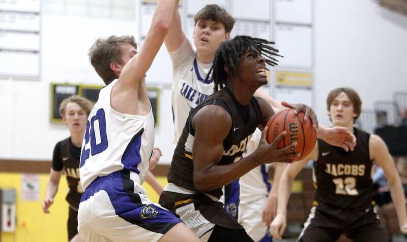 Jacobs’  Treval Howard navigates through heavy Lake Zurich traffic in Hinkle Holiday Classic boys basketball tournament game action at Jacobs High School Tuesday.