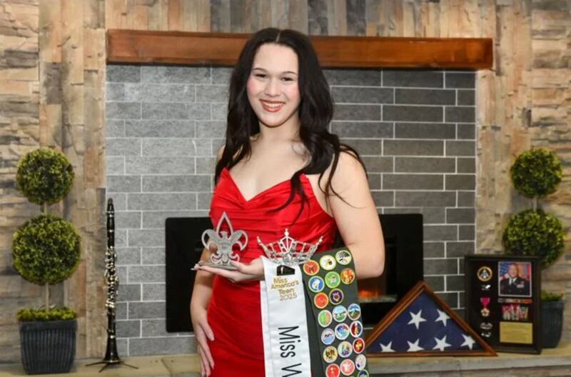 Alexis McCullough, 17, of Bourbonnais, poses with accolades she has earned through her many community involvements, including her Miss Will County’s Teen sash and crown, her scout badges and a pin for her Eagle Scout Service Project, which will bring a Gold Star Families Memorial Monument to Marcotte Park in Bourbonnais. McCullough raised $120,000 for her project, which is inspired by her father, Col. Mark McCullough, who died in 2019 on active duty.