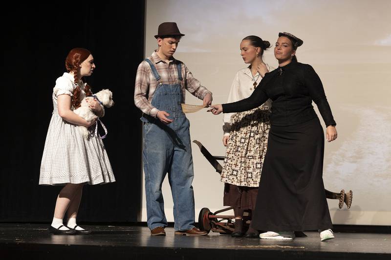 Cast members in Newman High School’s rendition of ‘The Wizard of Oz” rehearse a scene Wednesday, April 9, 2025, at Centennial Auditorium in Sterling.