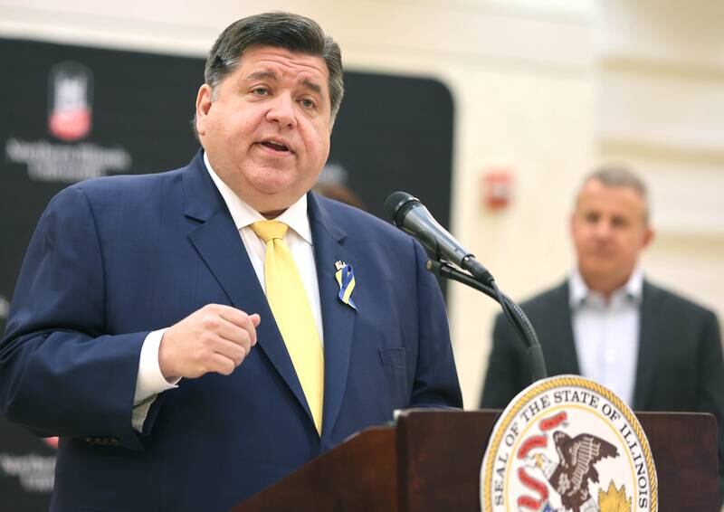 Illinois Gov. JB Pritzker speaks as DeKalb Mayor Cohen Barnes looks on Thursday, March 3, 2022, in the Barsema Alumni and Visitors Center at Northern Illinois University in DeKalb. Pritzker was on hand to talk about the importance of higher education and to tout some of the programs in Illinois that help make that education more accessible to all.