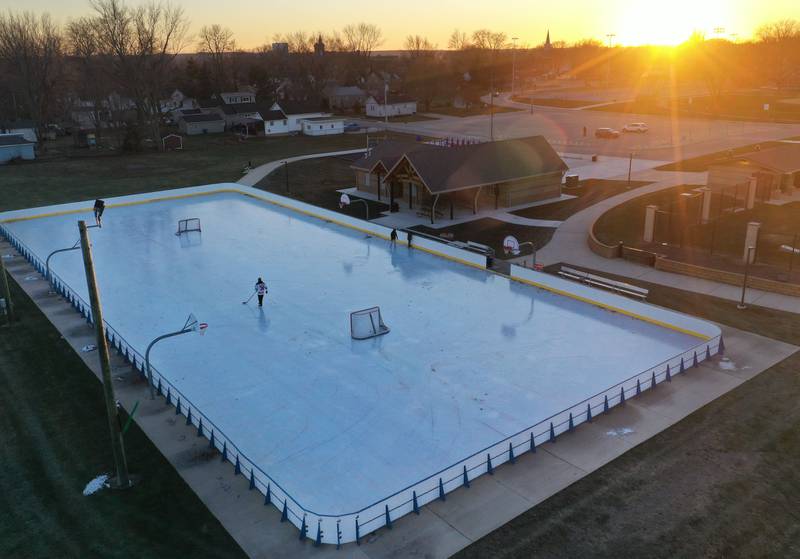 The sun sets over the ice rink on Thursday, Dec. 5, 2024 at Washington Park in Peru. The skating rink is no open for the winter season.
