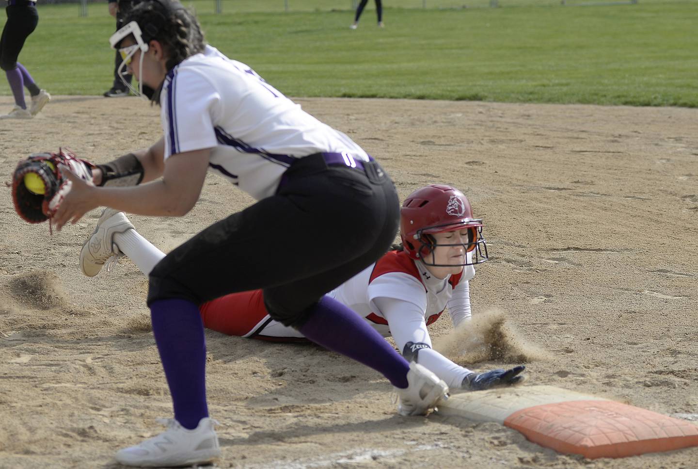 Streator’s Mya Zavada dives back into first base against Manteno on Tuesday, April 25, 2023, in Streator.