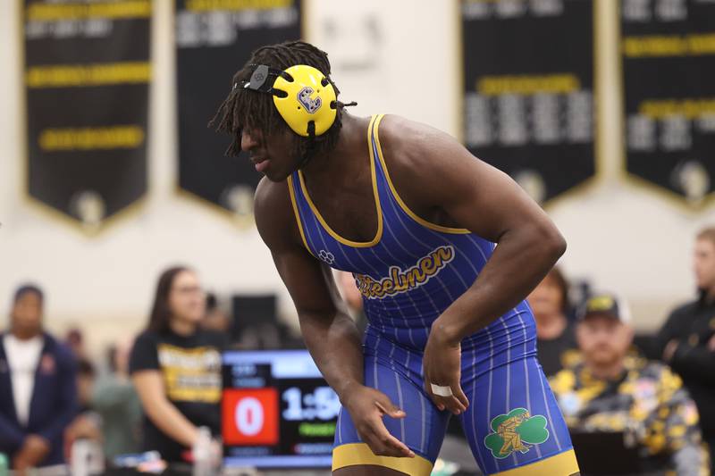 Charles Walker of Joliet Central faces off against Luke Chrisse of Yorkville in the 215-pound weight SPC Conference championship match at Joliet West on Saturday, Jan 25, 2025.