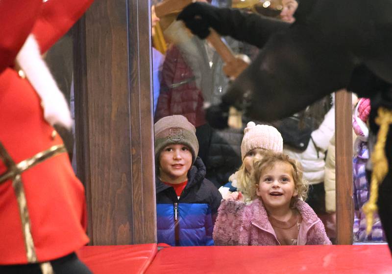 Children enjoy watching dancers from the Beth Fowler School of Dance perform the Nutcracker in the window of Pizza. Beer. Whiskey. Friday, Nov. 21, 2025, during Moonlight Magic in downtown Sycamore.