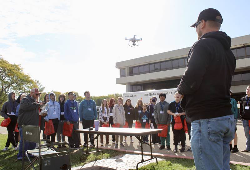 Michael Selover, left, assisted by Kevin Larsen, right foreground, activate a drone in a demonstration to eighth-grade students attending Pathway Playground on Friday, Oct. 14, 2022, at Sauk Valley Community College. The SVCC instructors explained how sensors on the drone can identify pest-infested areas of a field and download data to a computer in a tractor that enables more efficient means of applying chemical sprays.