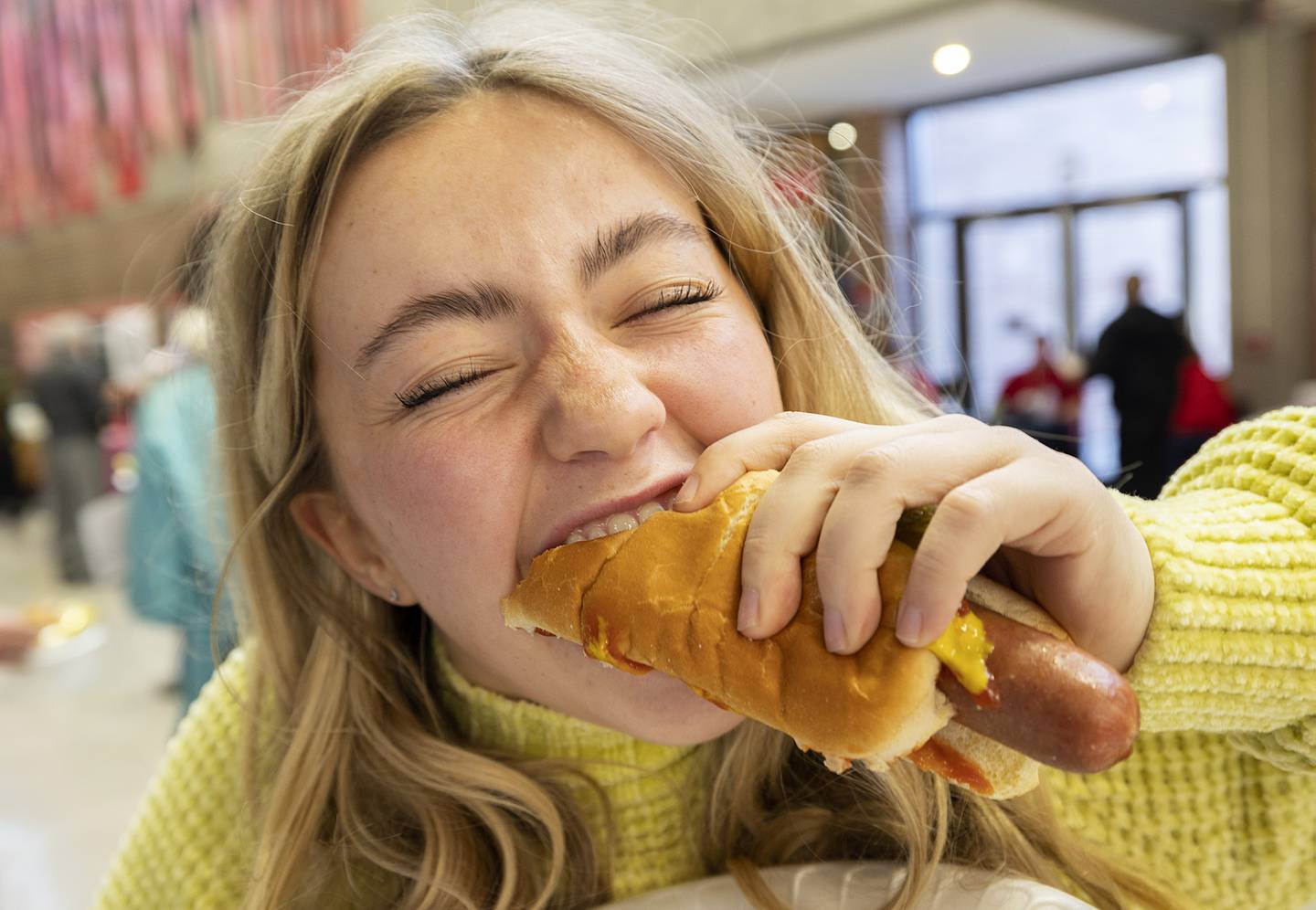 Chloe Coil of Dixon digs into a dog at SVCC’s SaukFest Wednesday, Feb. 1, 2023. Dog and burgers were a couple of the treats on the menu for the welcome back to school celebration.