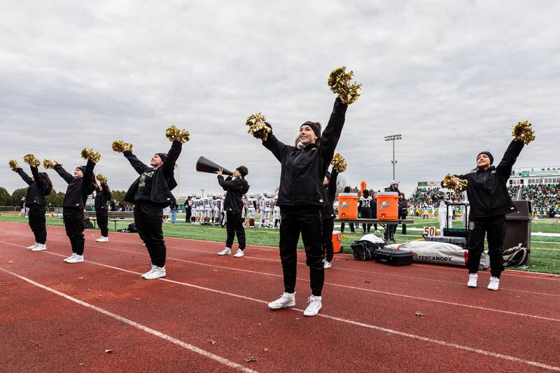 Oak Forest’s cheer team shares school spirit during a 5A varsity football semifinal game against Providence at Providence Catholic High School on Nov. 22, 2025.