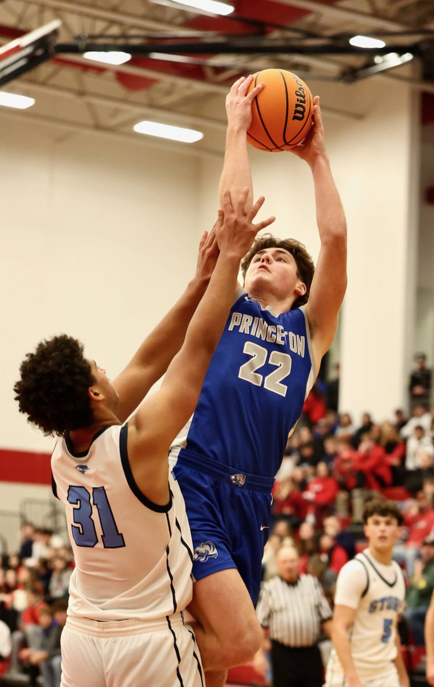 Princeton's Deacon Gutshall shoots over Bureau Valley's Dakarai Martin in Saturday's Colmone Classic action at Hall High School.