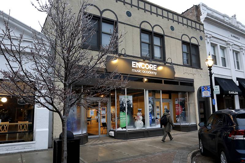 A person walks past the new Encore Music Academy on Feb. 22, 2022. The academy moved into its new location over Thanksgiving week last year. The larger location allows for the expansion of its private student instruction and also has a large space suitable for performing.