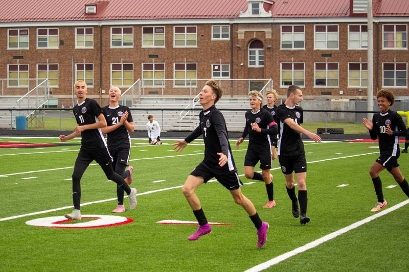 Manteno's Eric Eldridge, center, celebrates with his team as he scores the second goal of the game, advancing the lead 2-0, during Manteno's 3-0 victory in the Class 1A Momence Regional championship on Saturday, Oct. 25, 2025.