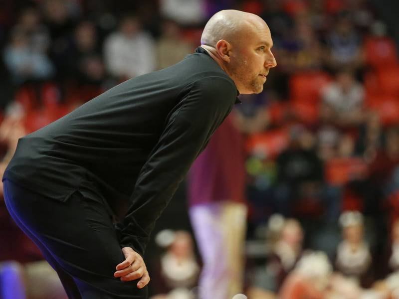 Downers Grove North head boys basketball coach James Thomas watches his team play against Moline during the Class 4A state semifinal game on Friday, March 10, 2023 in Champaign.