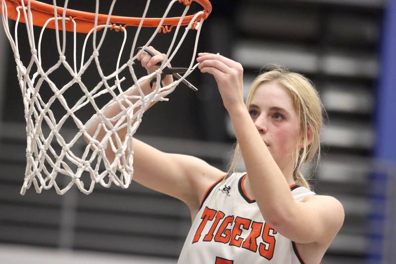 Crystal Lake Central’s Ruby Macke snips her piece of the net after a win over Burlington Central in IHSA Class 3A Regional Title Game girls basketball action on Thursday, Feb. 20, 2025, at  Central High School in Burlington.