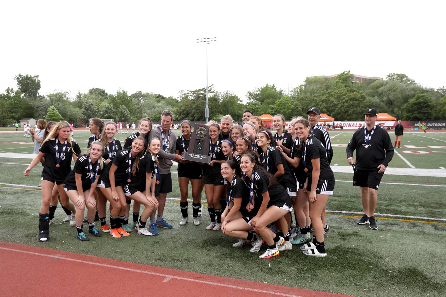 Fenwick players pose with their fourth-place trophy following their IHSA Class 2A State consolation game loss to Deerfield at North Central College in Naperville on Saturday, June 4, 2022.