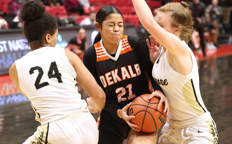 DeKalb's Alicia Johnson drives between Sycamore's Monroe McGhee and Mallory Armstrong during the First National Challenge Friday, Jan. 27, 2023, at The Convocation Center on the campus of Northern Illinois University in DeKalb.