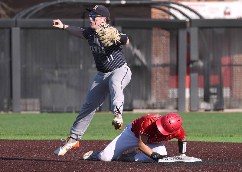 Hiawatha's Kamden Rasmus has to jump over South Beloit's Gabe Najera after tagging him out at second base Thursday, April 16, 2026, during their game at Northern Illinois University in DeKalb.