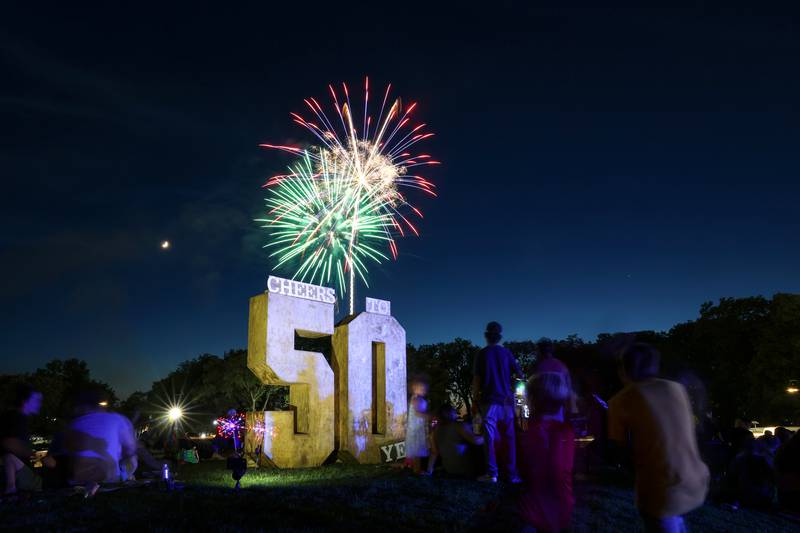 Spectators watch the fireworks show from the hill at The Grove during the 50th Bourbonnais Friendship Festival on Saturday, June 28, 2025.