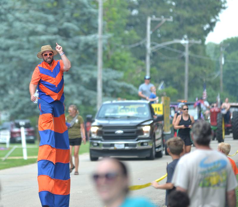 Stiltwalker Jason Kollum waves to the crowd during the German Valley Days parade on Saturday, July 15, 2023.