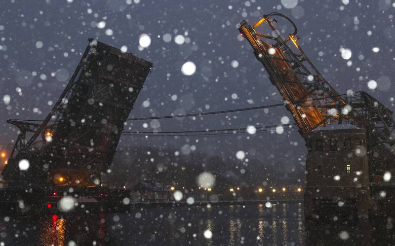 Snow falls on the Des Plaines River on 29, 2020, outside of City Hall in Joliet, Ill.