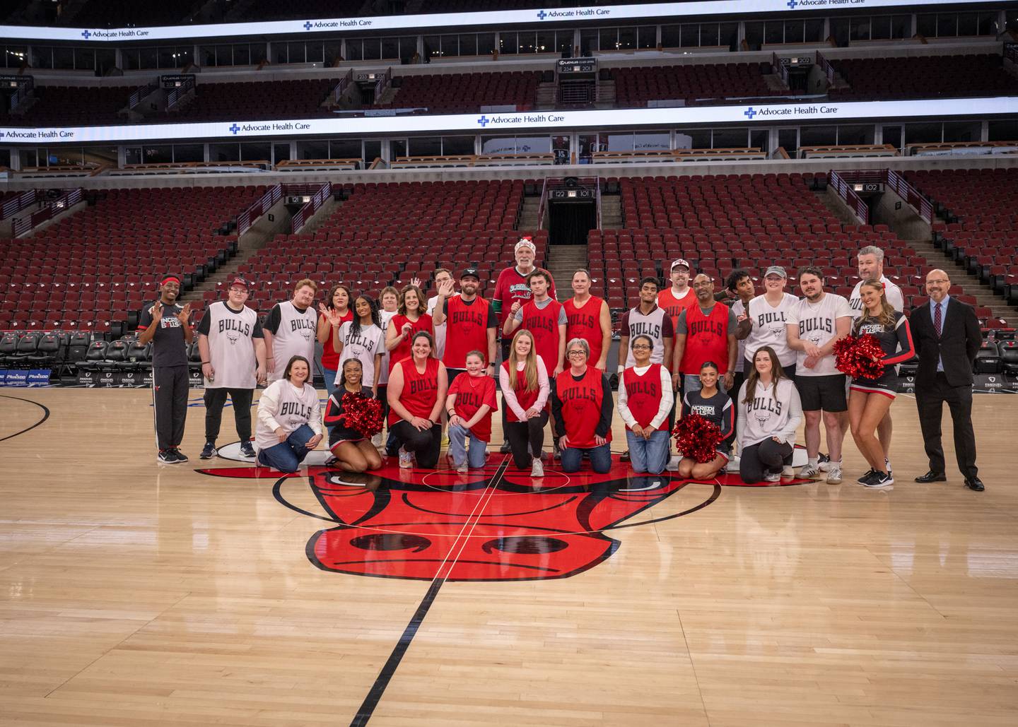 Participants in the "Court of Dreams" event Dec. 18 at the United Center in Chicago pose with their families after the scrimmage.