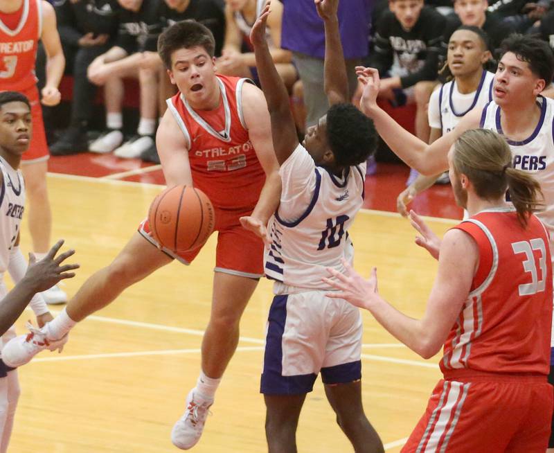 Streator's Logan Aukland passes the ball to teammate Quinn Baker as Plano's Davione Stamps defends during the Dean Riley Shootin' The Rock Thanksgiving Tournament on Monday, Nov. 20, 2023 at Kingman Gym.