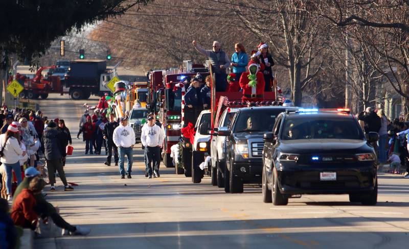 A parade makes its way along West Main Street as part of Merry Cary events Sunday, Dec. 8, 2024 in Cary.