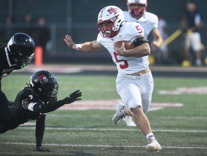 South Elgin's Ari Kravis (5) breaks a tackle for extra yards during Friday’s football game against Glenbard East in Lombard.