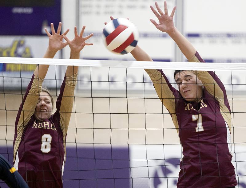Morris’ Ayla Phillips (left) and Rosemary Misener go up for a block against Sterling Tuesday, Oct. 29, 2024, at the class 3A regional semifinal in Dixon.