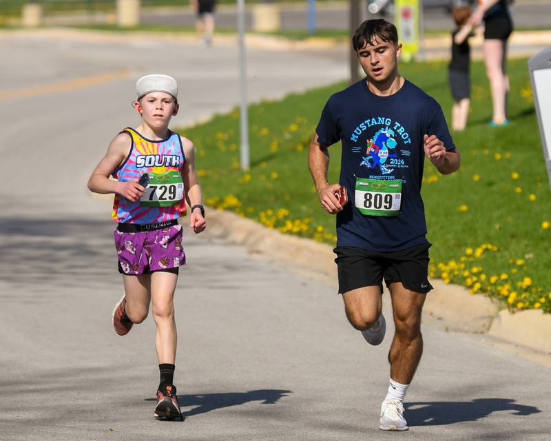 Glen McGowean (right) of Vernon Hills and William Caldwell (left) of Downers Grove finish the Mustang Trot race on Sunday April 14, 2024, held at Downers Grove South High School.