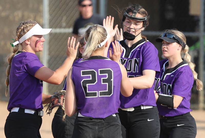 Dixon pitcher Elle Jarrett gets high-fives all around before the start of an inning during their game against Sycamore Thursday, May 12, 2022, at Sycamore High School.