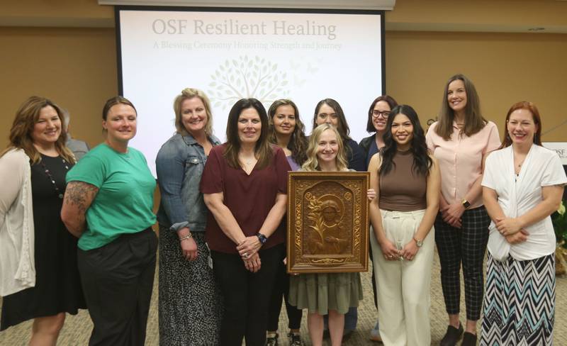 The OSF Resilient team poses for a photo holding a portrait of Saint Maria Goretti during a blessing event of the new OSF Resilient Healing care program that will represent hope, healing and a renewed commitment to the recovery of sexual assault survivors in the I‑80 Region on Friday, May 30, 2025 at OSF HealthCare Saint Paul Medical Center in Mendota. Saint Maria Goretti, was an Italian virgin martyr of the Catholic Church, and one of the youngest saints to be canonized. She was born to a farming family. Her father died when she was nine, and the family had to share a house with another family, the Serenellis.
OSF Resilient Healing care is offered at two locations: Ottawa and Mendota. These strategically chosen sites ensure that survivors throughout the region can get the care they need in a supportive, safe and accessible setting.