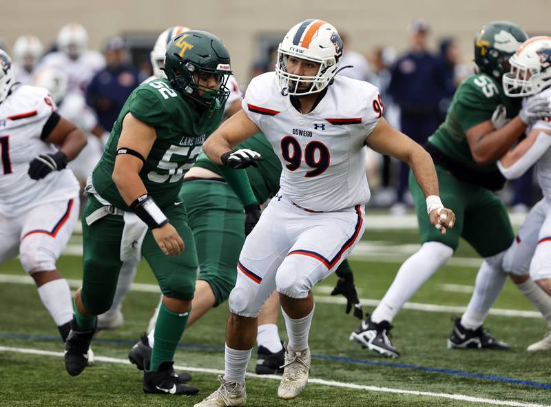 Oswego's Gianni Casurella (99) comes off the defensive line during the varsity football second-round 8A playoff game between Oswego and Lane Tech on Saturday, Nov. 8, 2025 in Chicago.