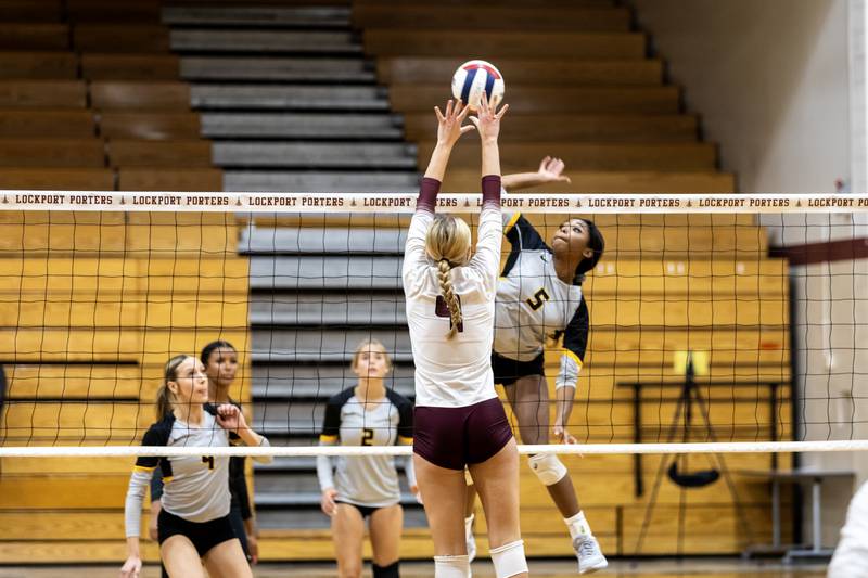 Joliet West's Mady Gant goes for the kill as Lockport's Sara Mcgraw attempts to block during a varsity volleyball game at Lockport Township High School on Sept. 17, 2025.
