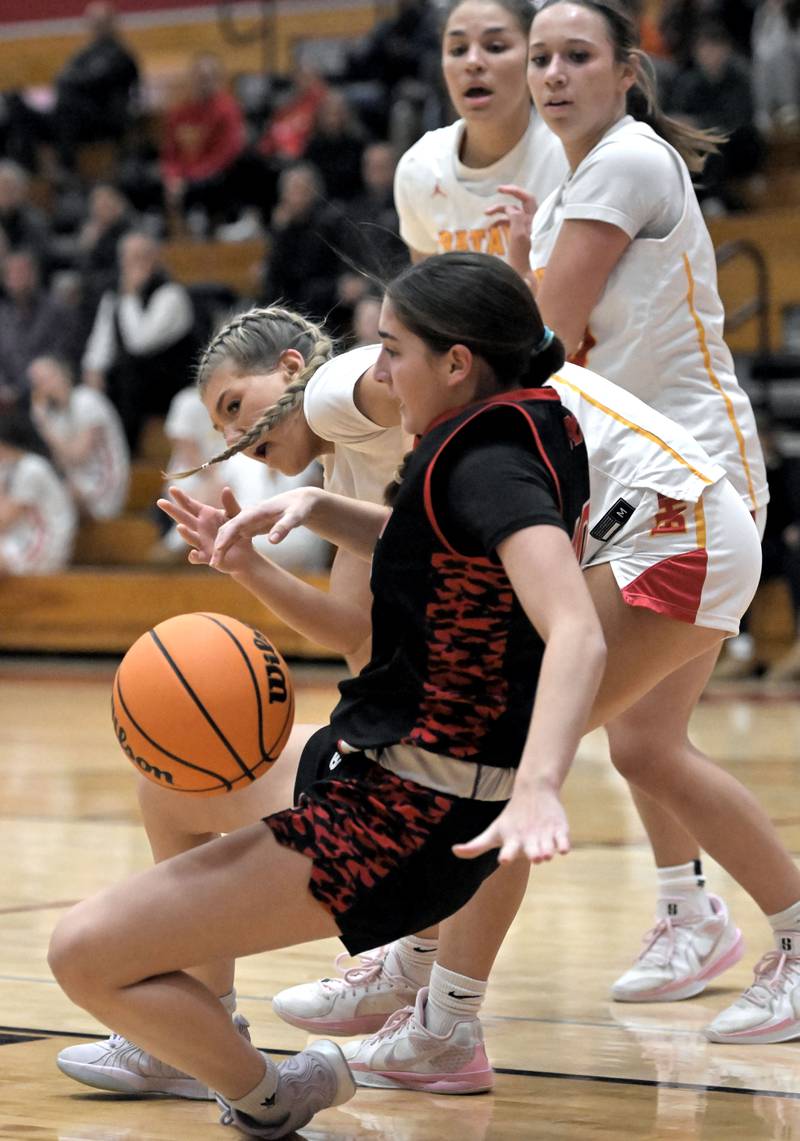 Batavia’s Natalie Warner forces a turnover by Maine South’s Amelia Fernandez in a girls basketball game in Batavia on Tuesday, Jan. 14, 2025.