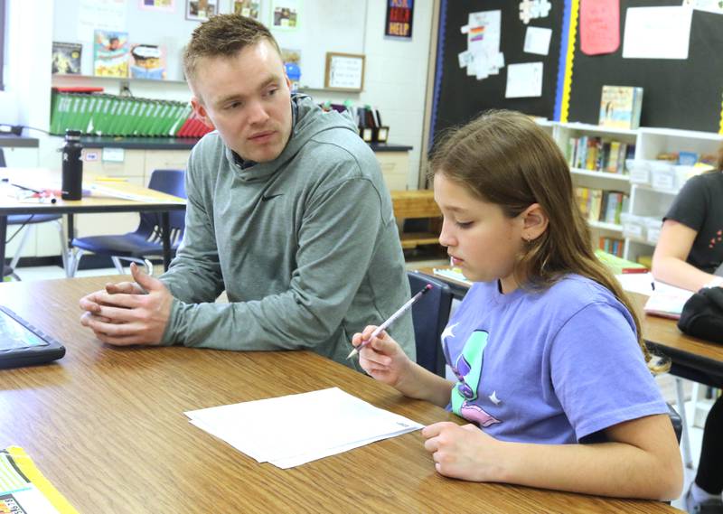 Jacob Winters, fourth grade teacher at South Prairie Elementary School, works with student Elowyn Wickenberg Wednesday, April 6, 2023, at the school in Sycamore.