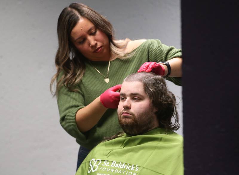 Daniel Taglia, has his head shaved by beautician Erika Reyes, during the first ever St. Baldrick's event on Wednesday, April 30, 2025 at Illinois Valley Community College.