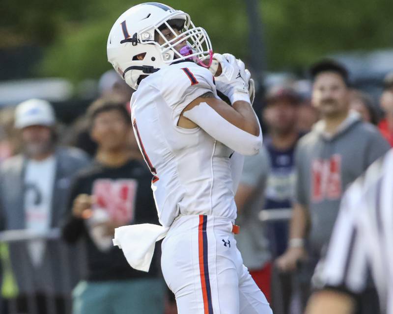 Oswego's Teddy Manikas (1) catches a touchdown in the endzone during football game between Oswego at Naperville Central  on Friday, Aug 29, 2025  in Naperville.