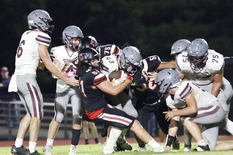 Panther defense trio #51 Derek Naftzger, #75 Caleb Reymer, & #50 Jordae Crow worked together to stop visiting Rockridge Rocket #23 Tanner Dye on Friday night in Erie.