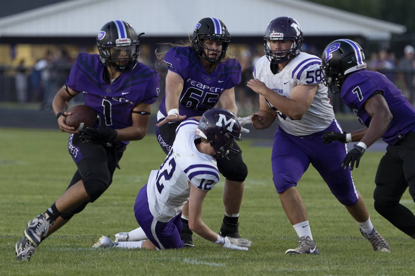 Plano junior quarterback Armando Martinez (1) runs through a hole during a game against Manteno on Friday, Sept. 2, 2022.