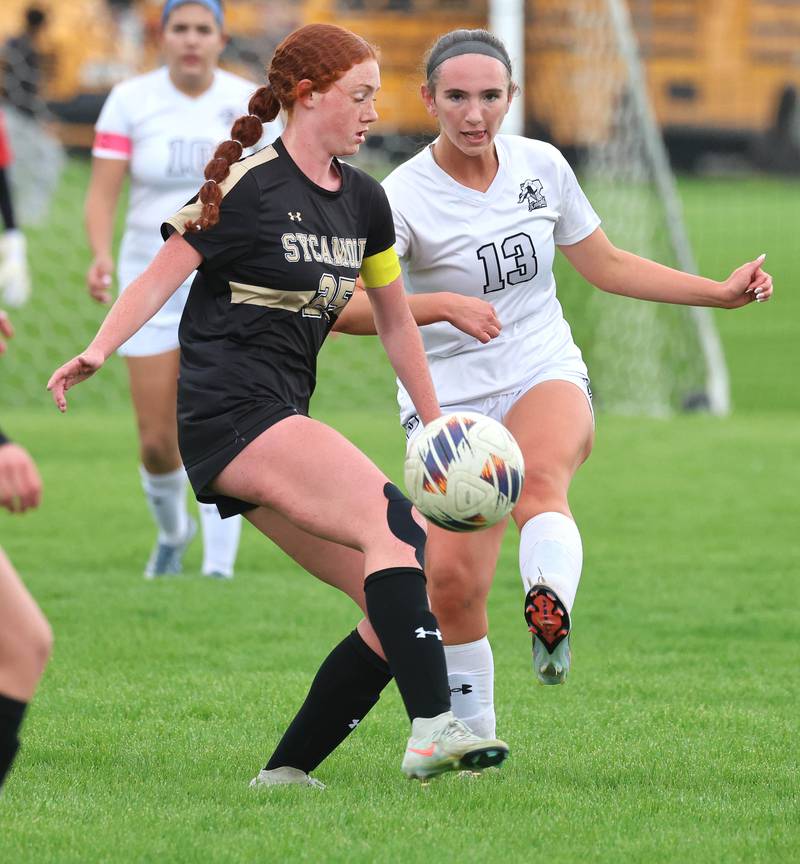 Sycamore's Isabelle Segreti tries to kick the ball away from Kaneland's Kyra Lilly during their game Wednesday, April 29, 2026, at Sycamore High School.