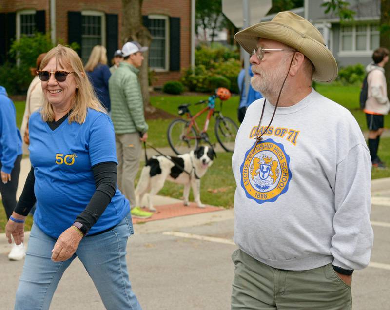 Lyons Township High School alumni Alaine and Todd Rapp of La Grange walk down Blackstone Avenue in La Grange  in the annual homecoming parade on Saturday, Sept. 24, 2022.