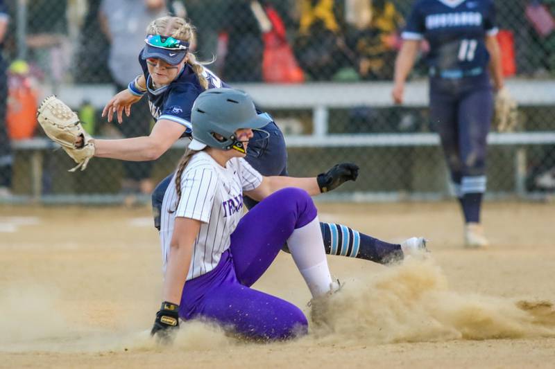 Downers Grove South's Julia Colorato (8) slides in before the tag at second during varsity softball game between Downers Grove South at Downers Grove North.  May 11, 2023.