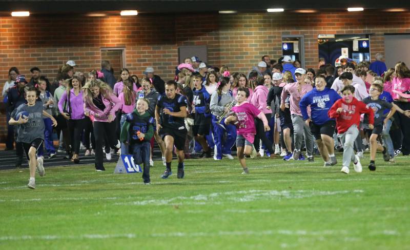 Kids run on to the field to congratulate the Tigers on a win over Mendota on Friday, Oct. 10, 2025 at Bryant Field in Princeton.