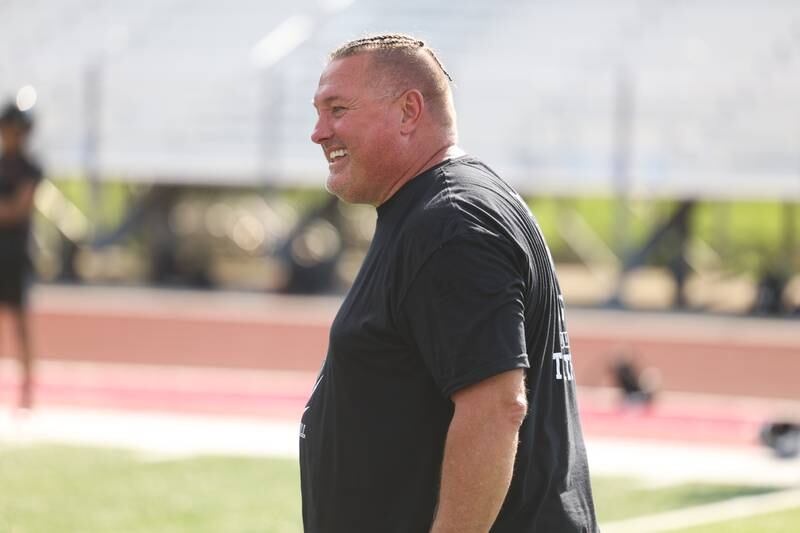 Bolingbrook head coach John Ivlow has a laugh between plays at the Morris 7 on 7 scrimmage. Tuesday, July 19, 2022 in Morris.