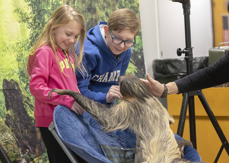 Raylynn (left), 6, and Brylen Bausman, 9, of Rock Falls visit with Rico the Sloth on Saturday, Feb. 7, 2026, at Rock Falls Tourism’s Flock to the Rock. The event was held at the American Legion and featured a menagerie of animals and speakers educating visitors about nature.