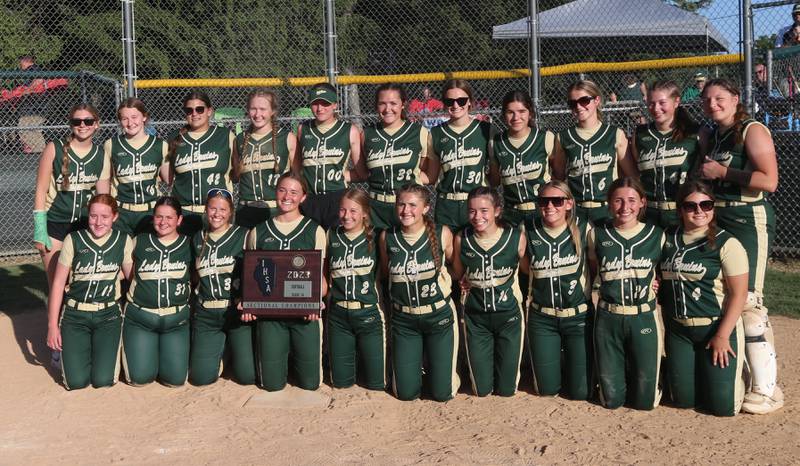 Members of the St. Bede softball team pose with the Class 1A Sectional plaque after defeating Biggsville 3-1 in the Class 3A Sectional championship on Friday, May 26, 2023 at St. Bede Academy.