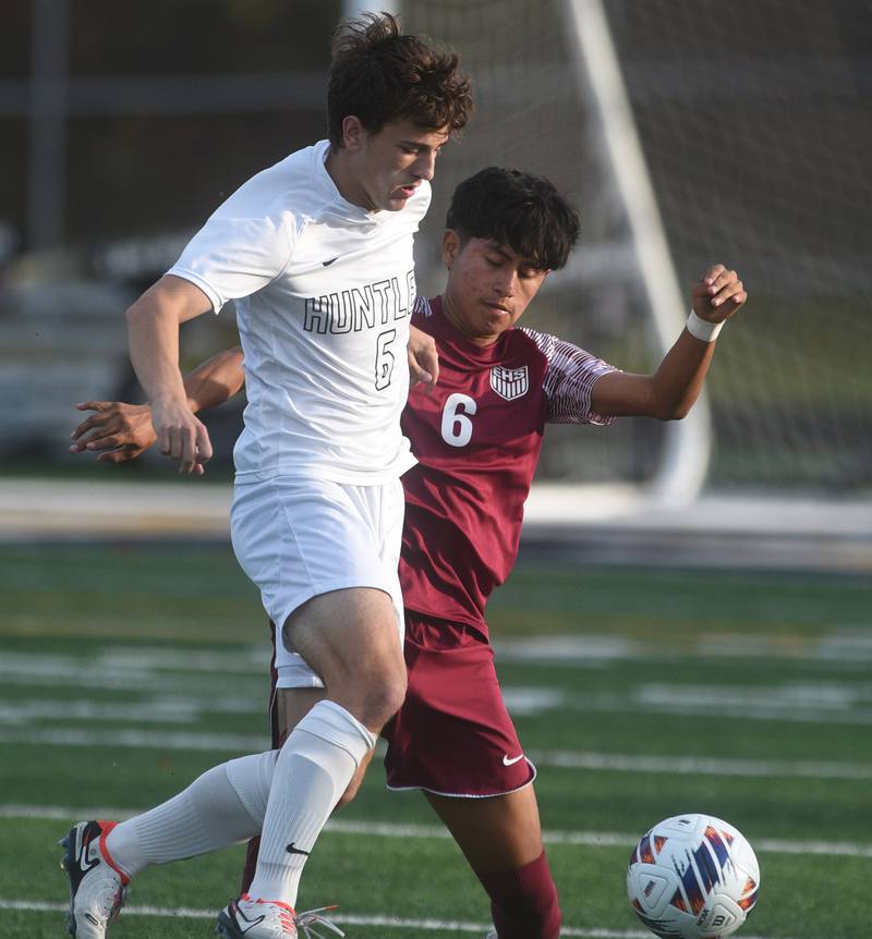 Huntley's Jack Breunig, left, moves past Elgin's Fernando Cuahquentzi during Tuesday’s IHSA class 3A sectional semifinal boys soccer game in Round Lake.