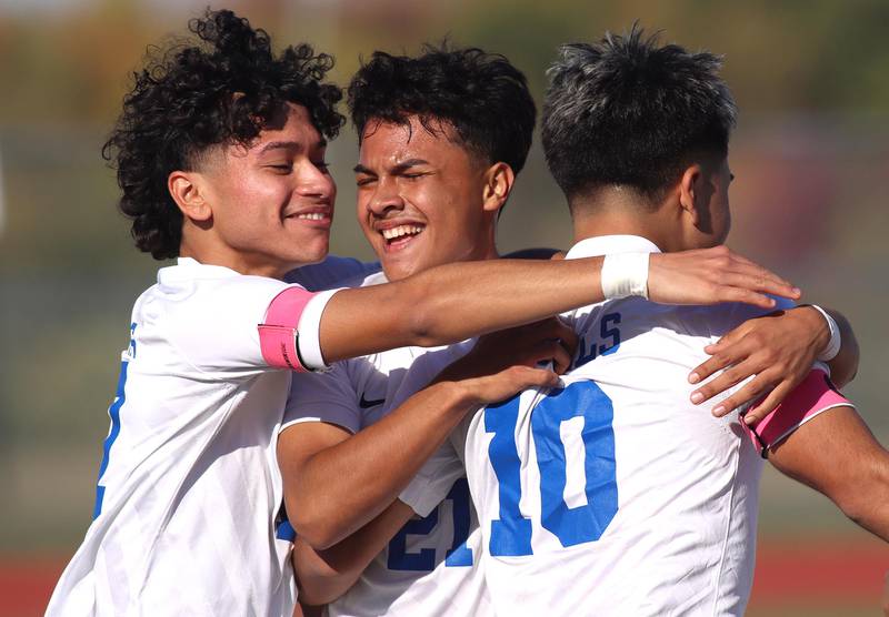 Larkin’s Adrian Diaz, 10, is greeted by Anthony Cordova, left, and  Joel Gutierrez, center, after Diaz’ second goal of the game in boys soccer regional action at South Elgin on Saturday. The Royals advanced to sectional action with a win over Huntley.