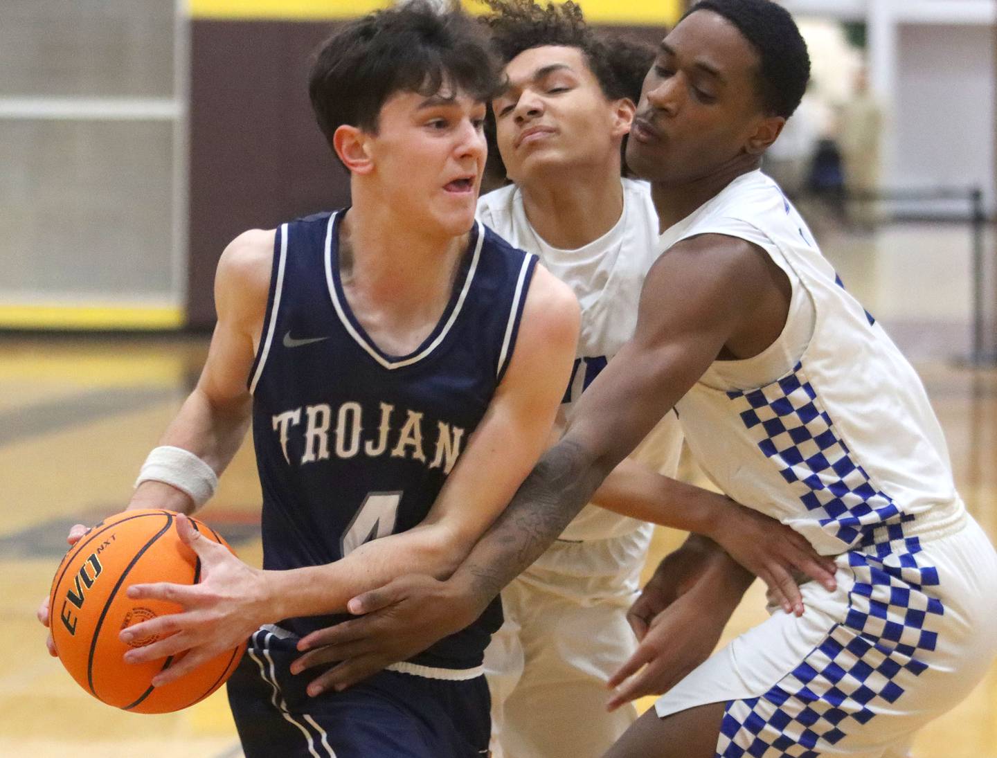 Cary-Grove’s Dylan Dumele, left, works under the hoop against Larkin’s Kamryn Bartee, center, and Jaevon Ligon, right, in varsity boys basketball Hinkle Holiday Classic action on Friday, Dec. 26, 2025, at Jacobs High School in Algonquin.