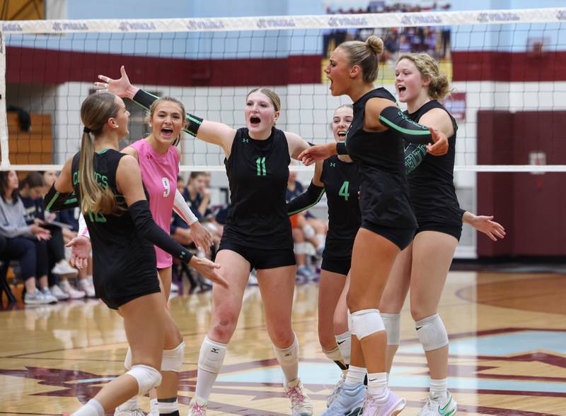 Providence players gather to celebrate a kill by Cali Tierney, left, during Providence's victory in two sets, 25-25, 25-18, over Lemont in the IHSA Class 3A Kankakee Sectional championship on Thursday, Nov. 6, 2025.