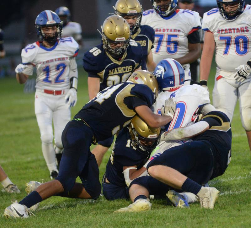 Polo defenders wrap up a Bushnell-Prairie City player on Friday, Aug, 29, 2025 in Polo.